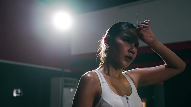 Asian sportswoman feeling tired or disappointed for failure training. hopeless and mental weakness concept