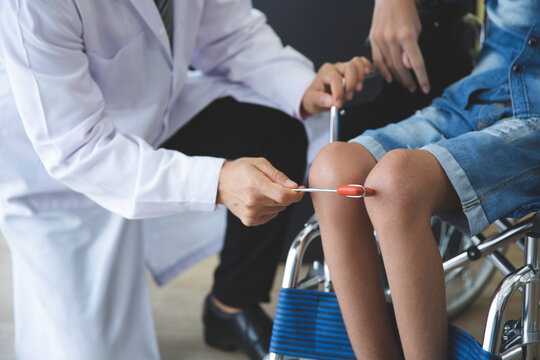 Asian orthopedic doctor checkup knee bone disability wheel chair patient  person , Disability handicap person health concept