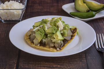 Traditional Mexican food.Beef leg toast with cream, lettuce and cheese,Beef leg toast with guacamole, sour cream, lettuce and cheese, accompanied by avocado slices.