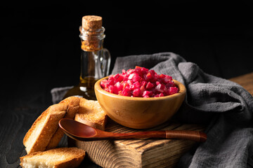 salad vinaigrette in a wooden cup on a dark background