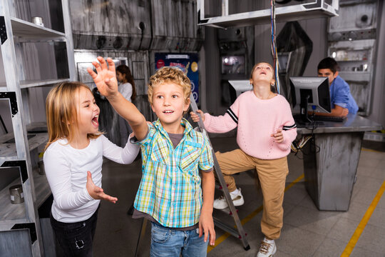 Little Girl Yelling At Boy Reaching For Something In Closed Quest Room Stylised As Abandoned Bunker