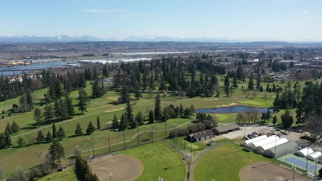 Cinematic aerial drone clip of Northwest Everett, Everett Community College, Legion Memorial Golf Course and nearby bedroom communities with Cascade Range North of Seattle by Puget Sound in Washington