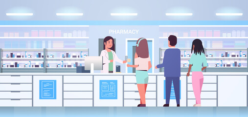 female doctor pharmacist giving pills to mix race customers patients at pharmacy counter modern drugstore interior medicine healthcare concept horizontal full length