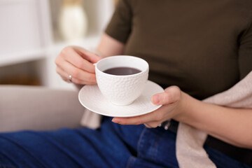 Close up of female hands with cup of tea