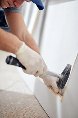 Young adult man working on a DIY budget renovation of his new home apartment.