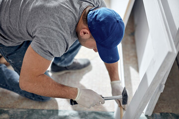 Young adult man working on a DIY budget renovation of his new home apartment.