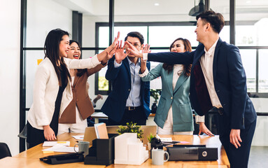Successful of group professional business people to win of celebrating project success.Creative business giving hi five  good teamwork together at office