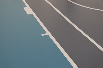 Painting line, Epoxy resin  applied to the floor. blue and grey colored floor in gym