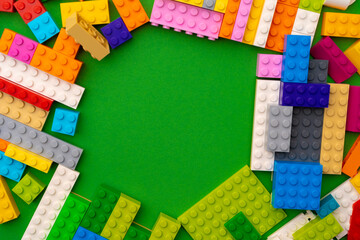 Details of kids plastic constructor on green background