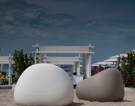 Many White And Gray Beanbag Chairs At An Outdoor Beach Cafe