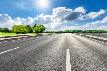 Fototapeta premium Asphalt road and green forest in spring season.