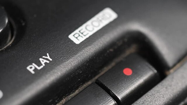 Audio cassette playback. Close-up. Pressing a finger rec button on an old audio cassette player. Man finger presses the rewind control buttons.