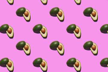 seamless pattern of avocados on a pink background