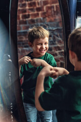 Fototapeta na wymiar Portrait of a cheerful, smiling, stylishly dressed little boy