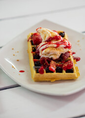 Strawberry waffles shot from side angle