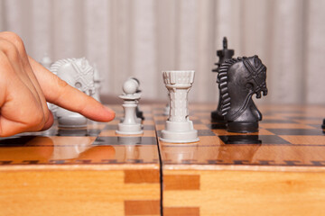  Woman playing chess game makes his move. Concept of business strategy and tactic.