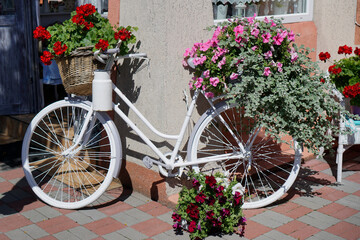 Fototapeta na wymiar Old White Cycle decorated with bunch of flowers