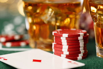 Cards, playing chips and alcohol in glass