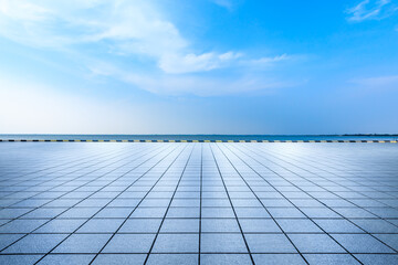 Empty square floor and lake landscape under the blue sky.