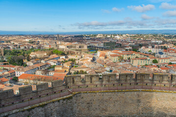Aerial view of the city of Carcassonne with the church from the castle of Carccasonne, background blue sky