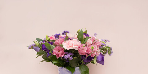 Bouquet with pink flowers on a light background.