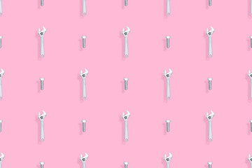 Adjustable metal wrench seamless pattern. Background from a metal wrench and a bolt. 