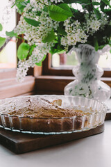 Spring flowering. Jasmine flowers in a vase. A cup of tea.