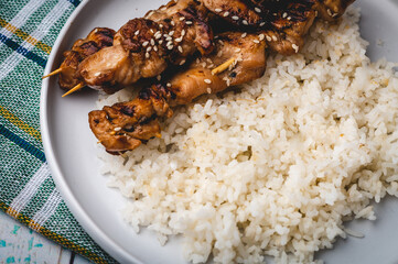 Grilled Asian Chicken Barbecue (BBQ)  seasoned with seasoned with sesame seeds (with rice flat lay)

