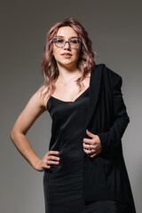 Business woman in glasses in a black dress