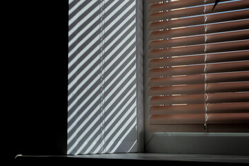 close-up - striped shadow from the blinds on the window