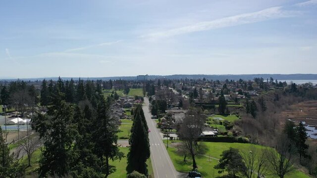 Cinematic aerial drone clip of Northwest Everett, Everett Community College, Legion Memorial Golf Course and nearby bedroom communities with Cascade Range North of Seattle by Puget Sound in Washington