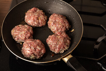 The process of cooking and roasting beef meat cutlets in a frying pan