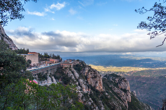 Breathtaking view of the Montserrat mountain range on a sunny spring day near Barcelona, Catalonia, Spain. Colorful mountain landscape. The shadow of the clouds falls to the ground.