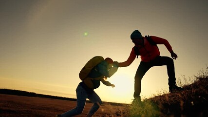 Teamwork business group. Climbing teamwork concept. Group of tourists lend helping hand while climbing to top of mountain. Helping hand in business. Business concept in teamwork.