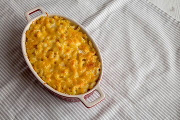 Homemade Macaroni and Cheese Pasta on cloth, low angle view. Space for text.
