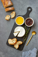Camembert cheese with toasts, honey and jam. Wine snack.