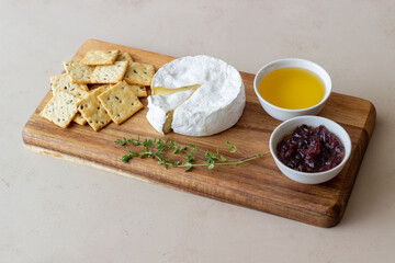Camembert cheese with cracker, honey and jam. Wine snack.