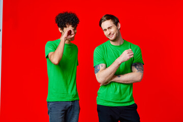 two men in green t-shirts laugh communication joy