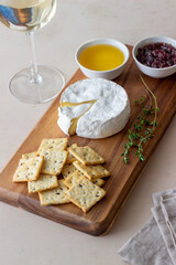 Camembert cheese with cracker, honey and jam. Wine snack.