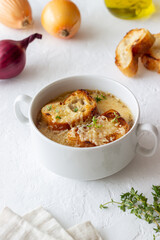 French onion soup with toasts and cheese. French cuisine. Vegetarian food.