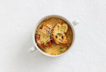 French onion soup with toasts and cheese. French cuisine. Vegetarian food.