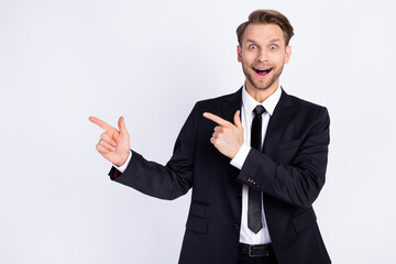 Photo of young excited man happy positive smile indicate fingers empty space ad advice choice isolated over grey color background