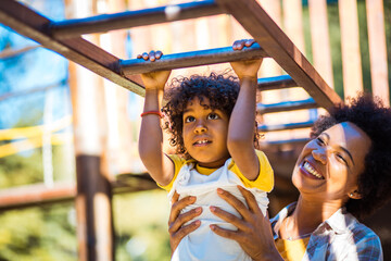 Mother and daughter on playground. - 426589276