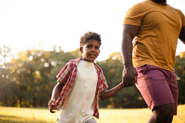 Obraz premium African American father and son in nature.