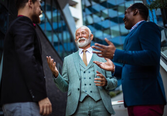 Three business men talking.