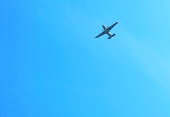 A plane flying in the blue sky.