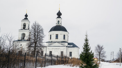 landscape with a rural orthodox church in winter