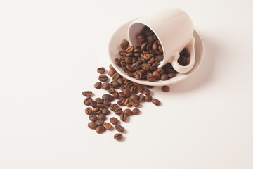 Coffee cup and coffee beans on white background