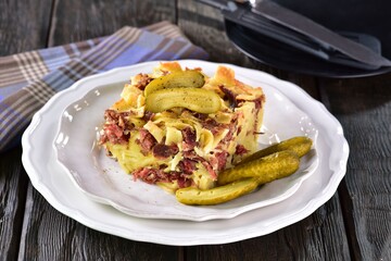 Baked ham and egg pasta, traditional Czech food called sunkofleky, with pickles