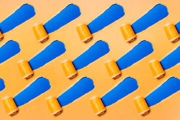 Pattern of diagonally torn yellow paper on blue background.